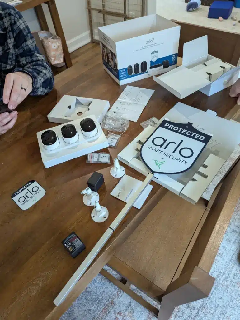 Arlo wireless security camera system components laid out during installation by Horus Community Services in Trumansburg, NY