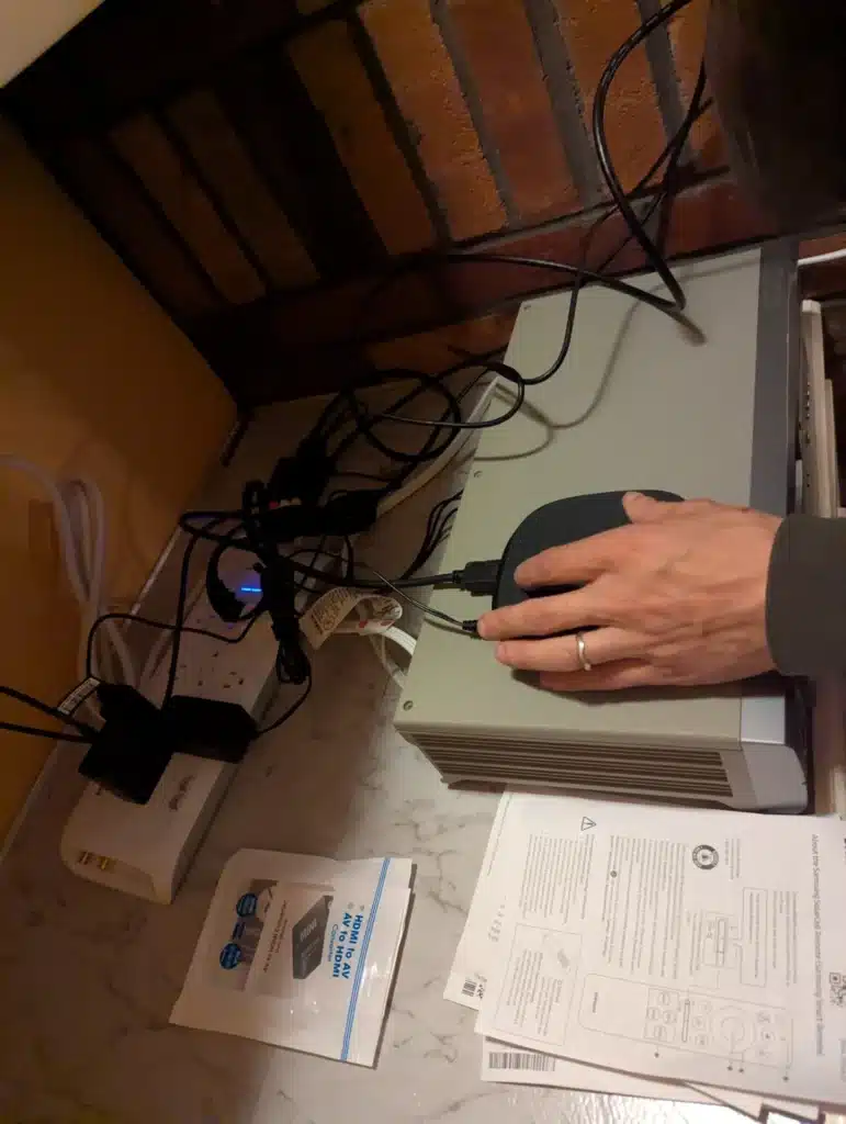 Horus Community Services technician organizing cables and home network equipment in Trumansburg, NY