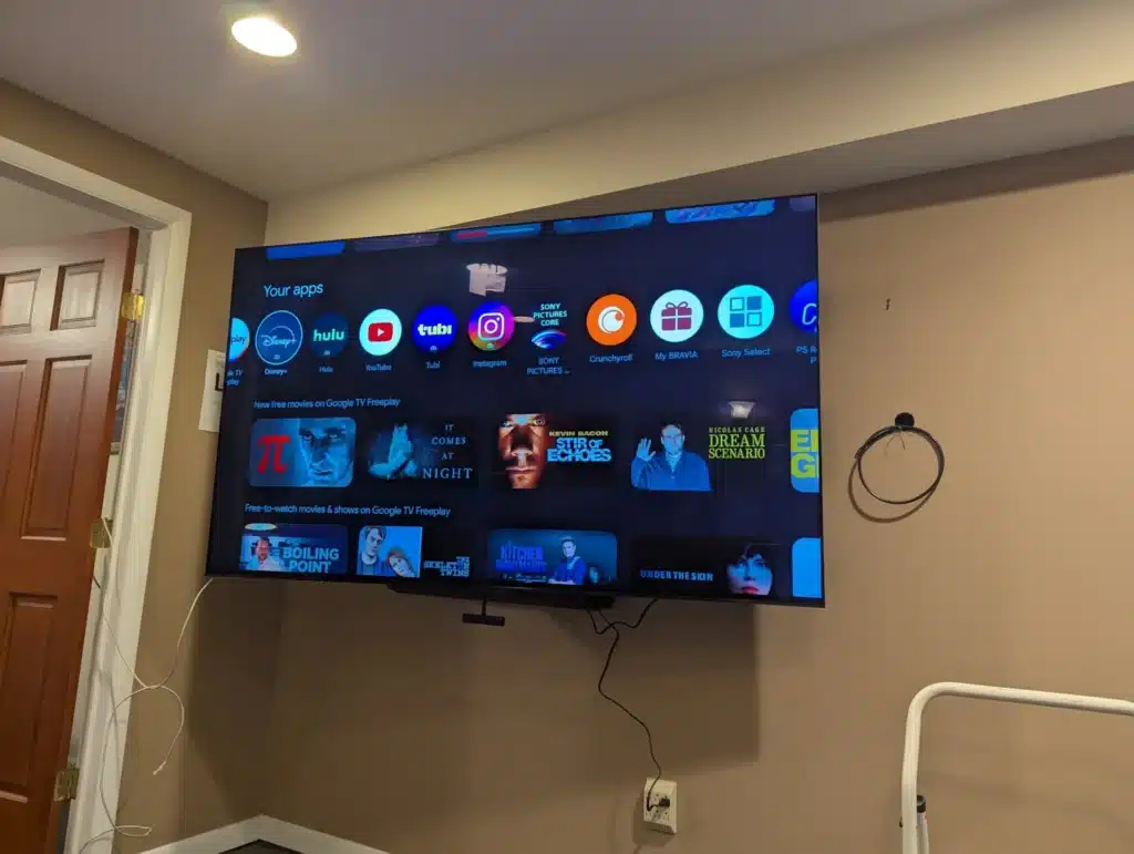 Completed corner-mounted TV showing smart TV apps, installed by Horus Community Services in Trumansburg, NY