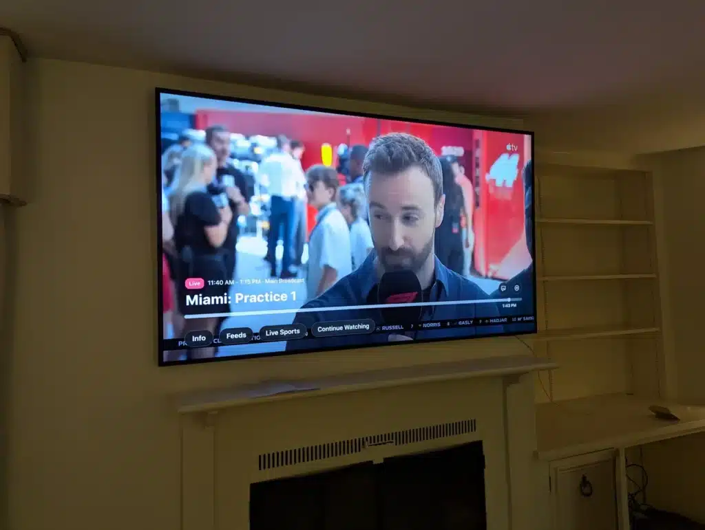 Completed TV mounted above a fireplace streaming live sports, installed by Horus Community Services in Trumansburg, NY