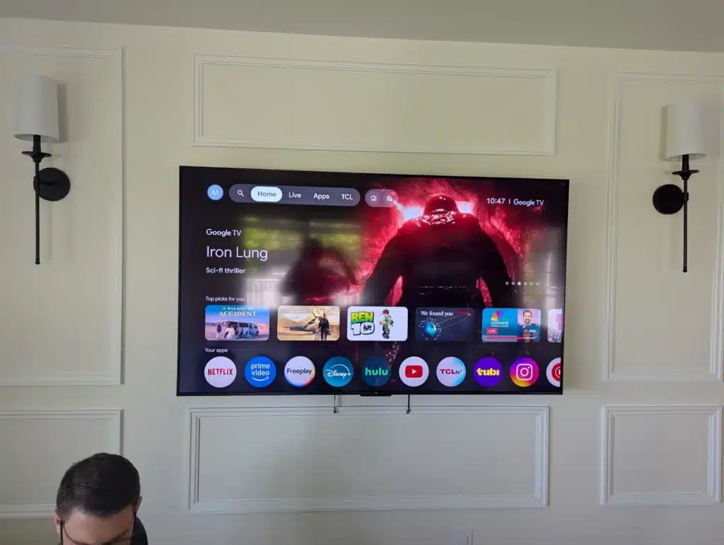 Completed smart TV mounted on a white framed living room wall by Horus Community Services in Trumansburg, NY