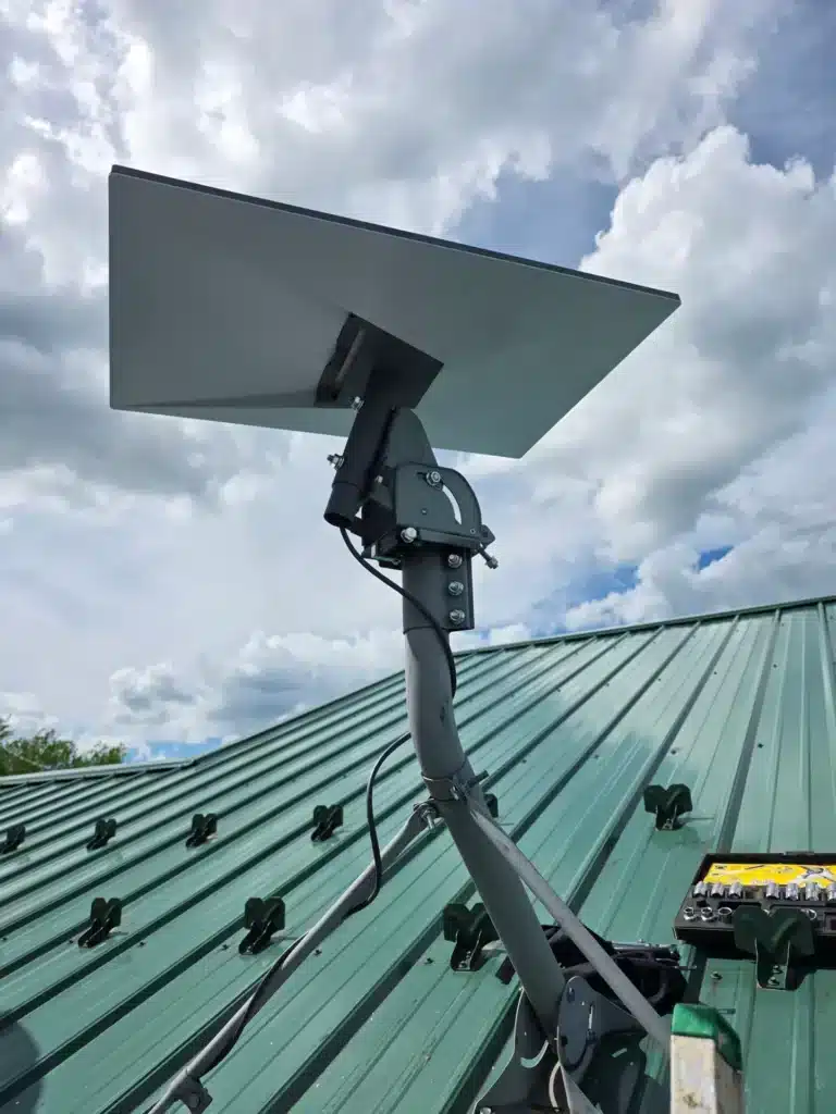 Completed Starlink satellite dish mounted on a green metal roof by Horus Community Services in Trumansburg, NY