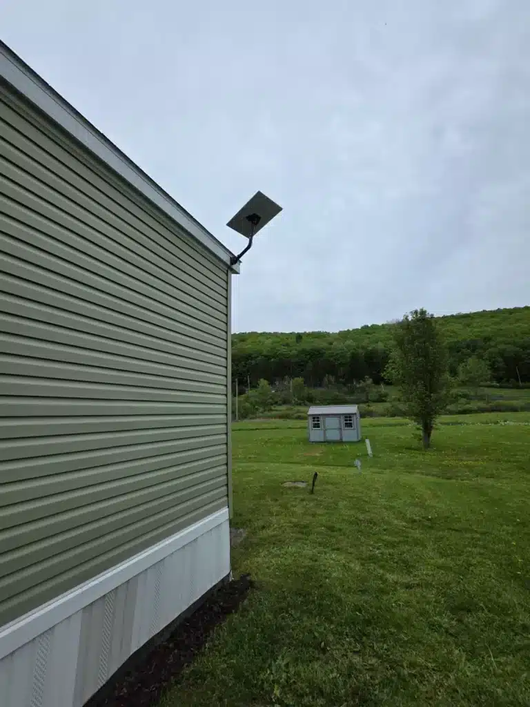 Completed Starlink satellite dish mounted on the side of a home by Horus Community Services in Trumansburg, NY