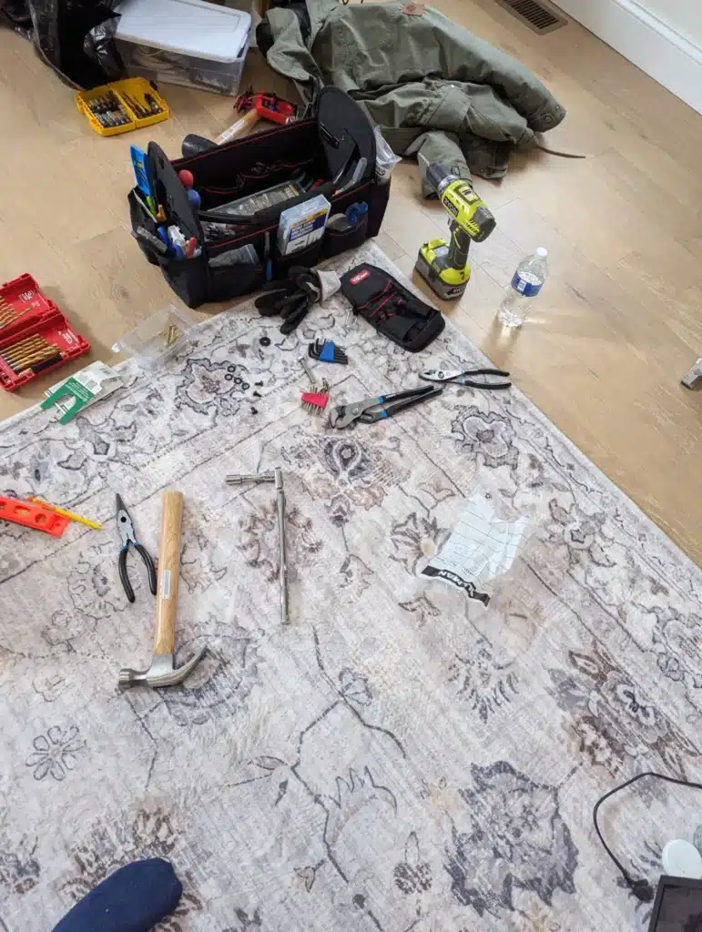 Horus Community Services installation tools laid out on protective covering at a Trumansburg, NY home