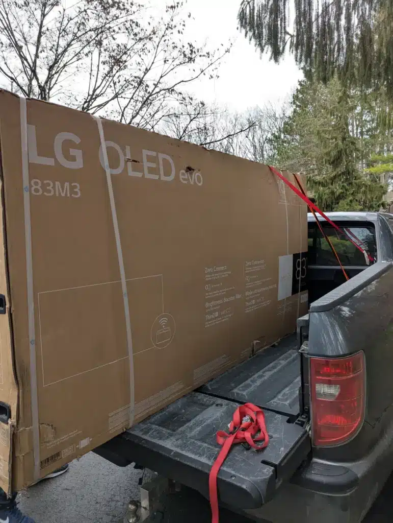 New LG OLED television secured in a truck bed for delivery and installation by Horus Community Services in Trumansburg, NY