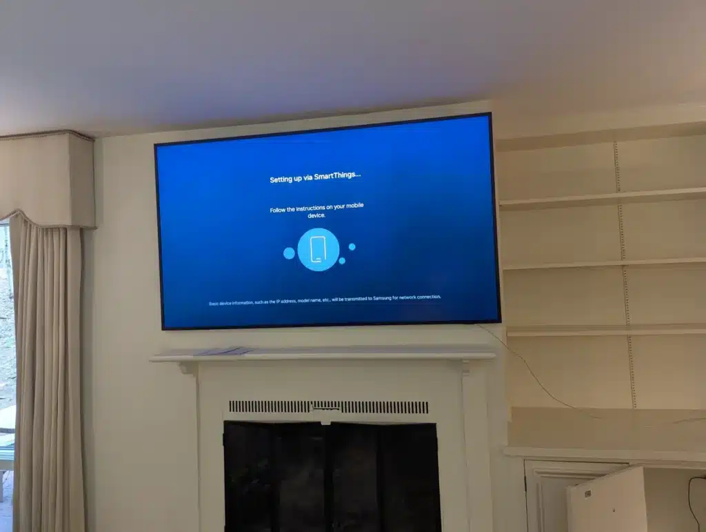 Fireplace-mounted Samsung TV running SmartThings setup during a Horus Community Services install in Trumansburg, NY
