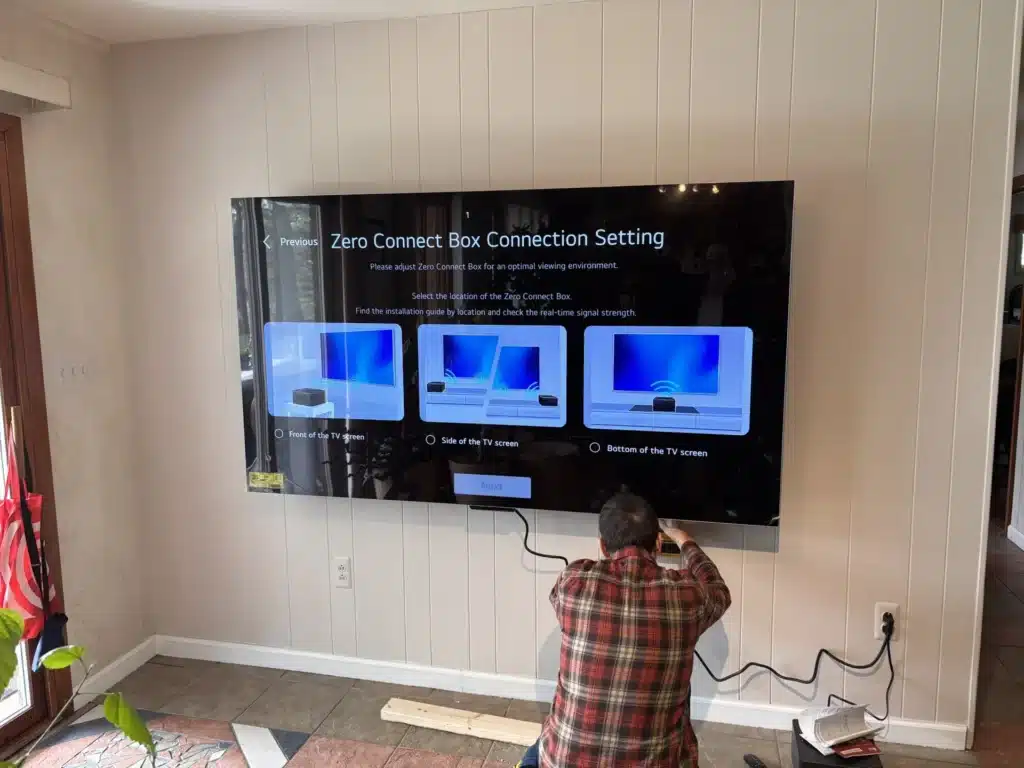 Wall-mounted Samsung TV showing the Zero Connect Box setup screen during a Horus Community Services install in Trumansburg, NY