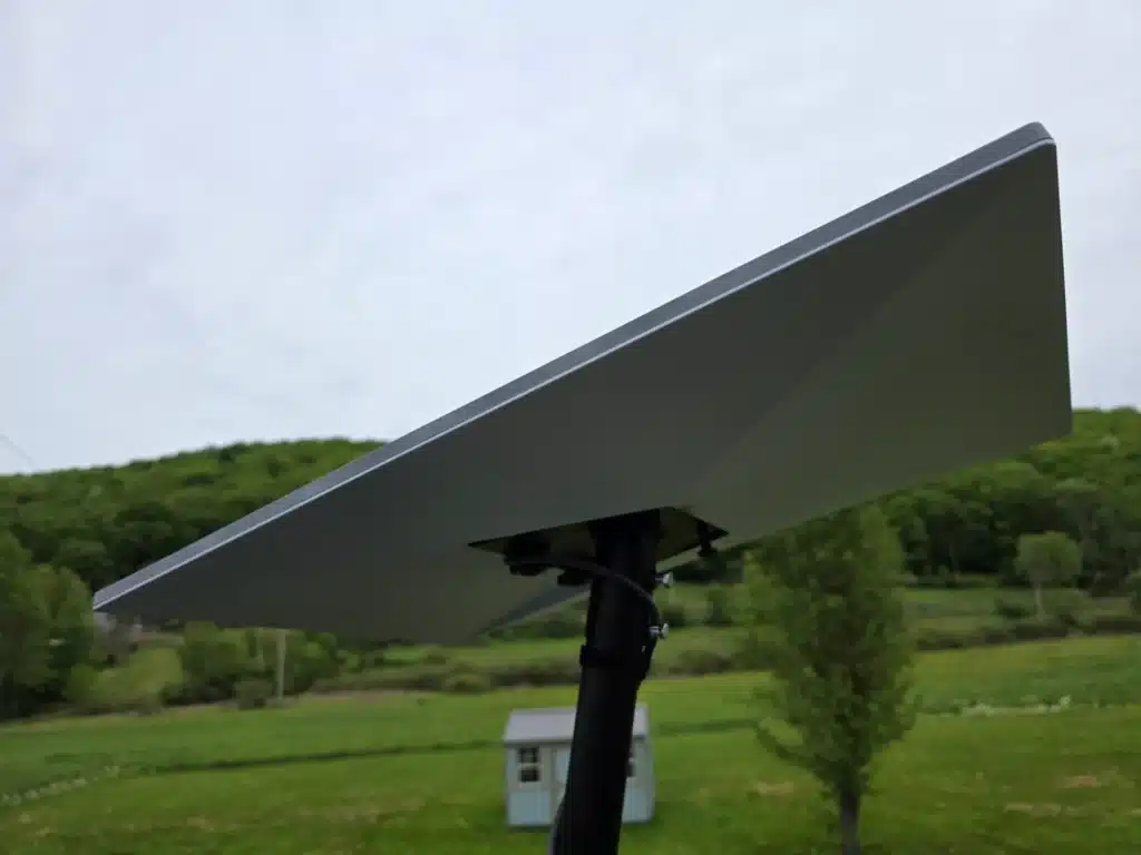 Close-up of a Starlink satellite dish mounted outside by Horus Community Services in Trumansburg, NY