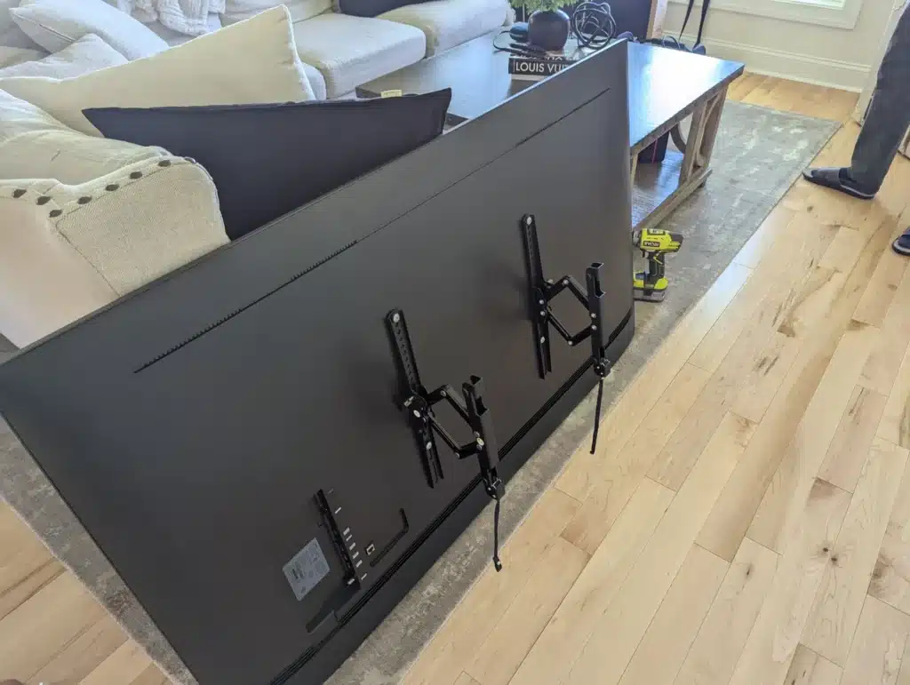 TV mounting brackets prepared on the back of a television before installation by Horus Community Services in Trumansburg, NY